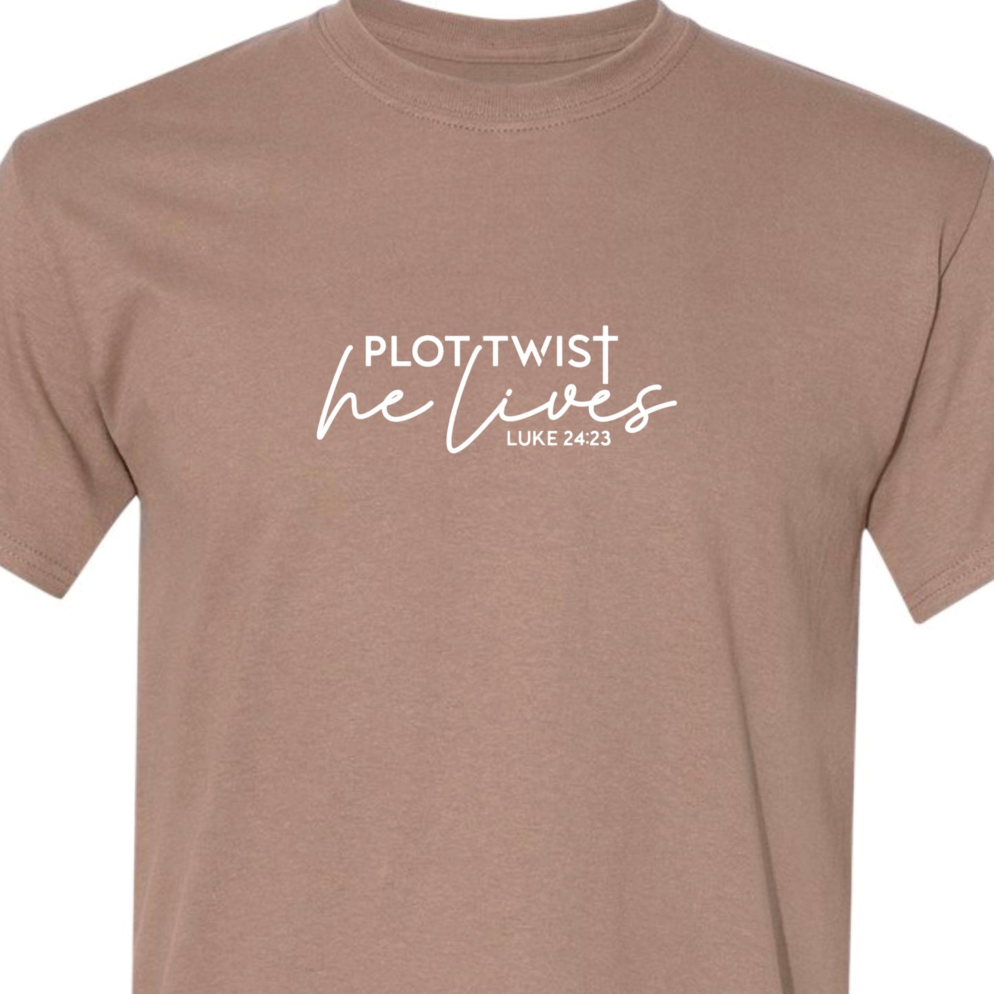 Light brown adult tshirt that reads, in white lettering: Plot Twist, He Lives - Luke 24:23